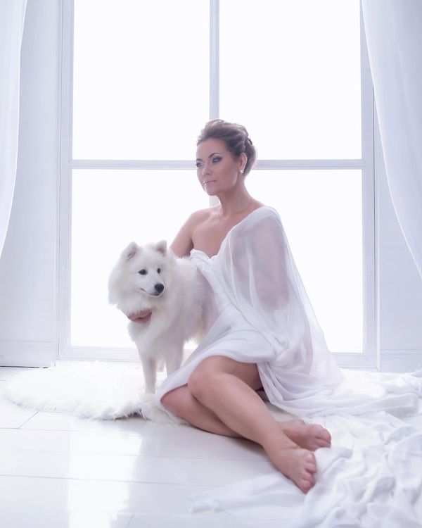 Woman with a serene expression focusing, with soft light on her face.